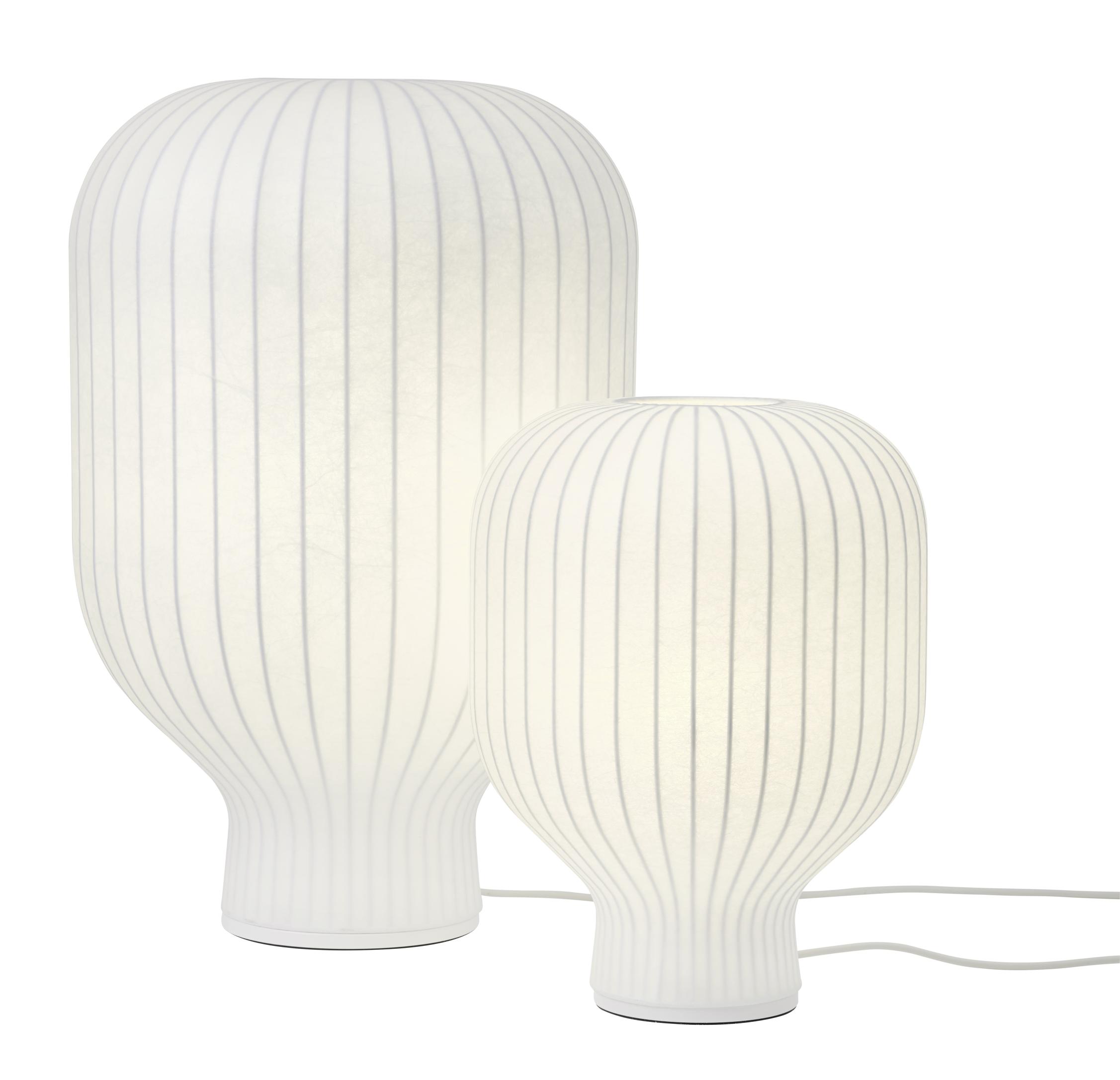 Zwei weiße Muuto Strand Tischleuchten mit geripptem Lampenschirm für stimmungsvolle Beleuchtung.