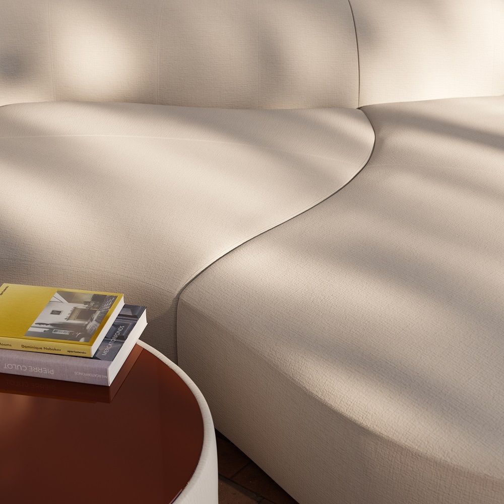 Detailaufnahme: Beiger Siwa Couchtisch von Cor mit Büchern auf einem runden Beistelltisch.