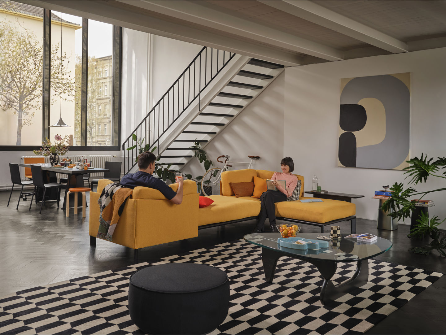 Wohnzimmer mit gelbem Sofa, das durch Vitra Anagram Plattformverbinder verbunden ist. Möbeldesign und Einrichtung.