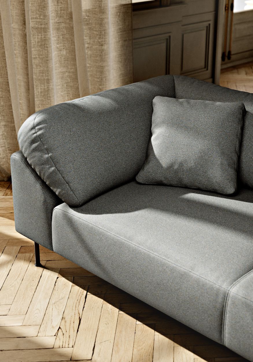 Detailaufnahme des grauen Collar Sofas von Woud, ein moderner 3-Sitzer mit Kissen.
