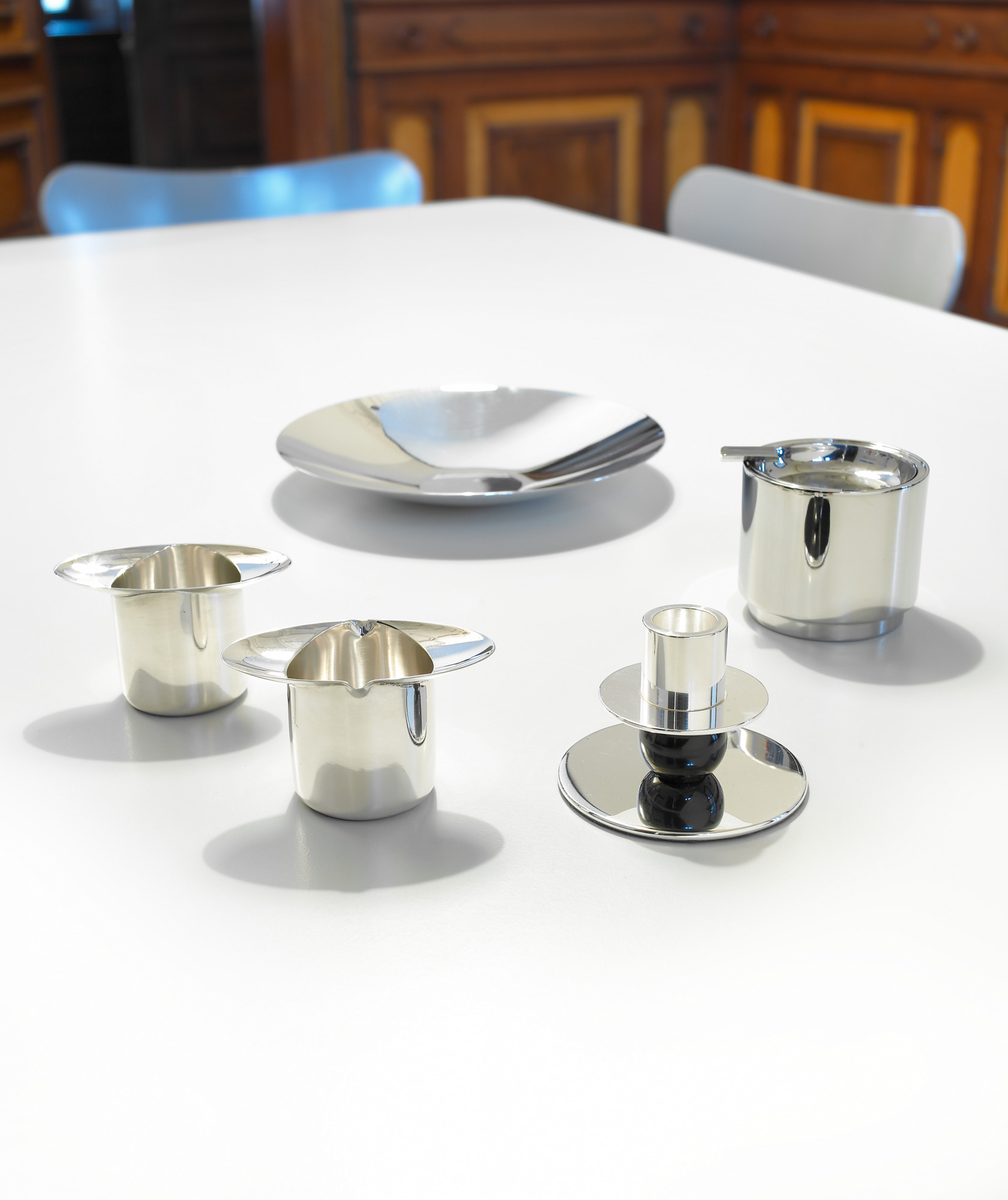 WSNK 87 Bauhaus Kerzenleuchter und Tischaccessoires von Tecnolumen aus glänzendem Metall auf weißem Tisch.