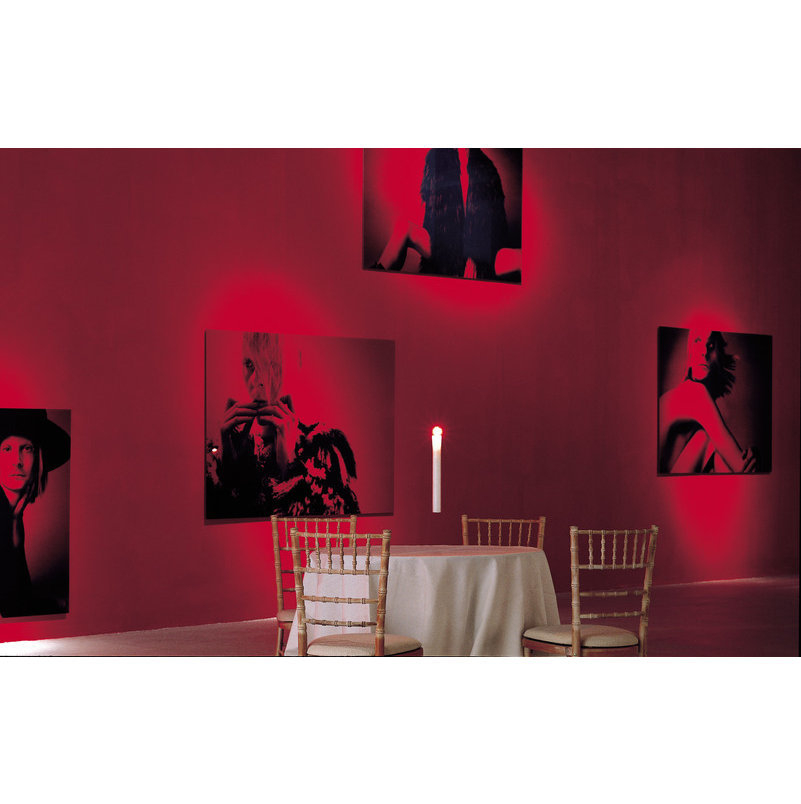 Fly Candle Fly! Hängekerze von Ingo Maurer über Esstisch in rotem Raum mit Bildern.