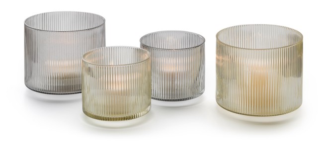 Vier gerippte Windlichter in Grau- und Goldtönen, inklusive Philippi Line Windlicht, mit Teelichtern auf weißem Untergrund.