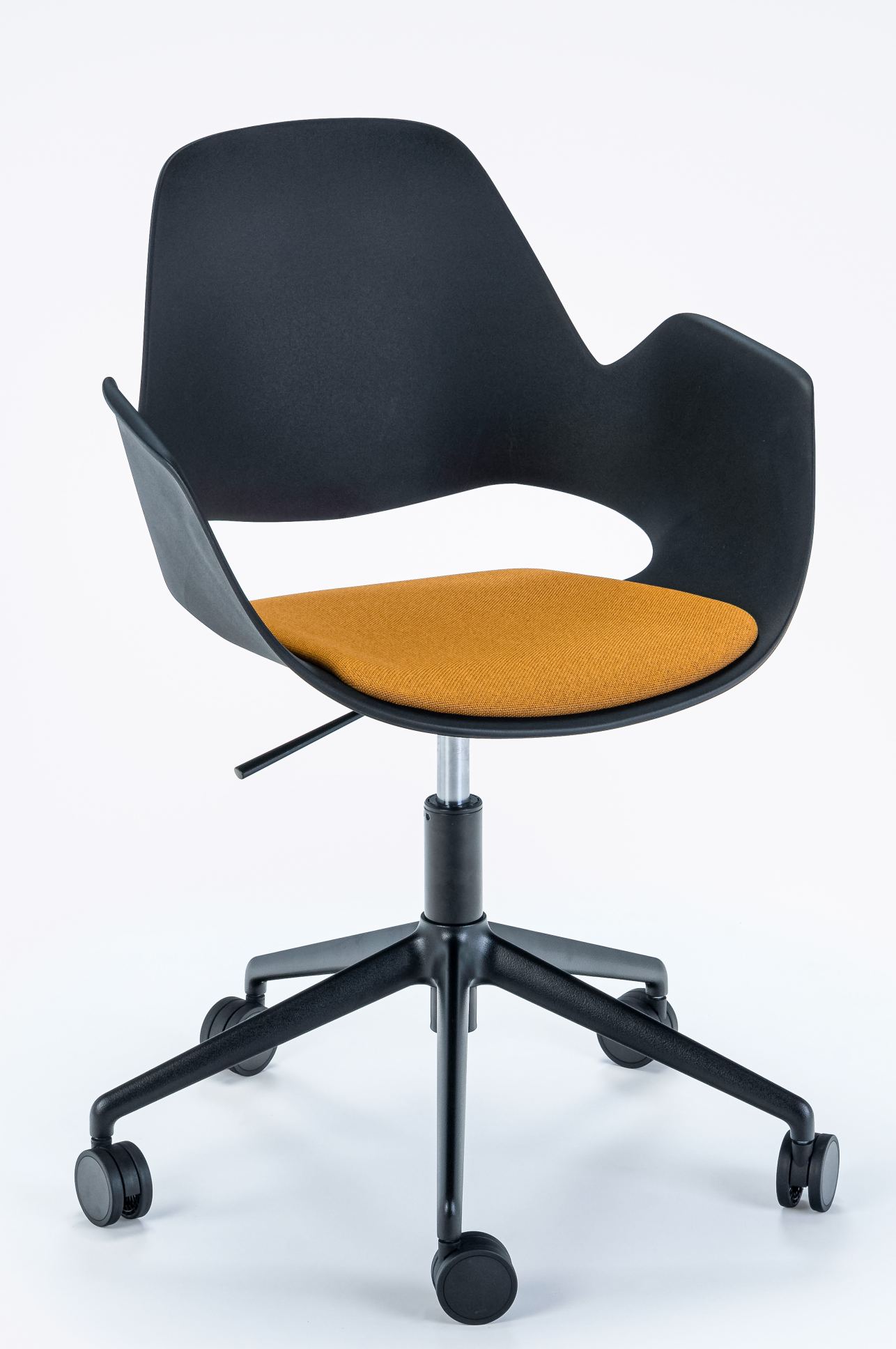 Falk Drehstuhl von Houe mit schwarzer Sitzschale und orangefarbenem Sitzkissen auf Rollen.
