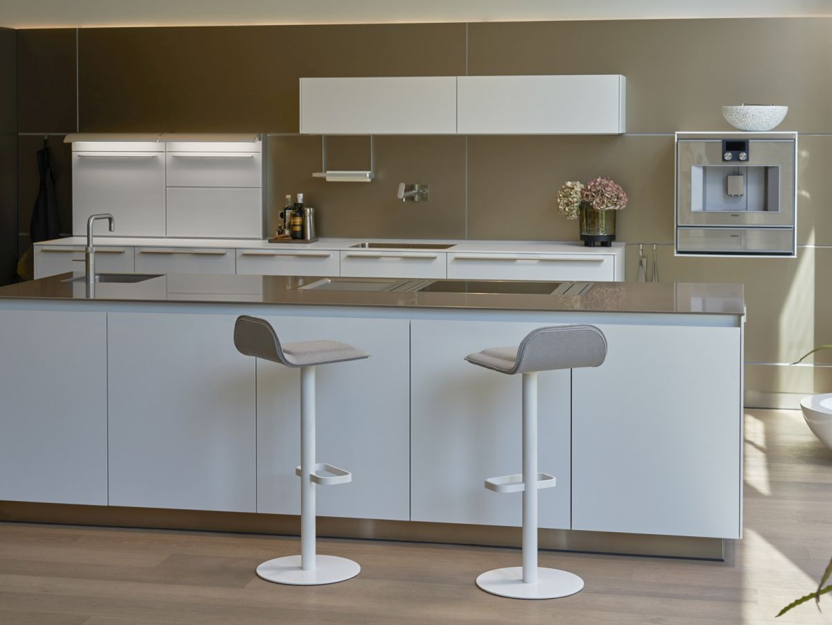 Zwei graue Dave Barhocker von Moree vor einer modernen weißen Kücheninsel.
