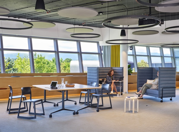 Heller Büroraum mit Vitra MedaMorph Klapptisch, Stühlen und Personen in Sitznischen.