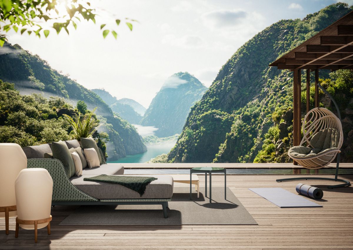 Loon Bodenleuchte von Dedon, beige, auf einer Terrasse mit Sofa und Bergblick.