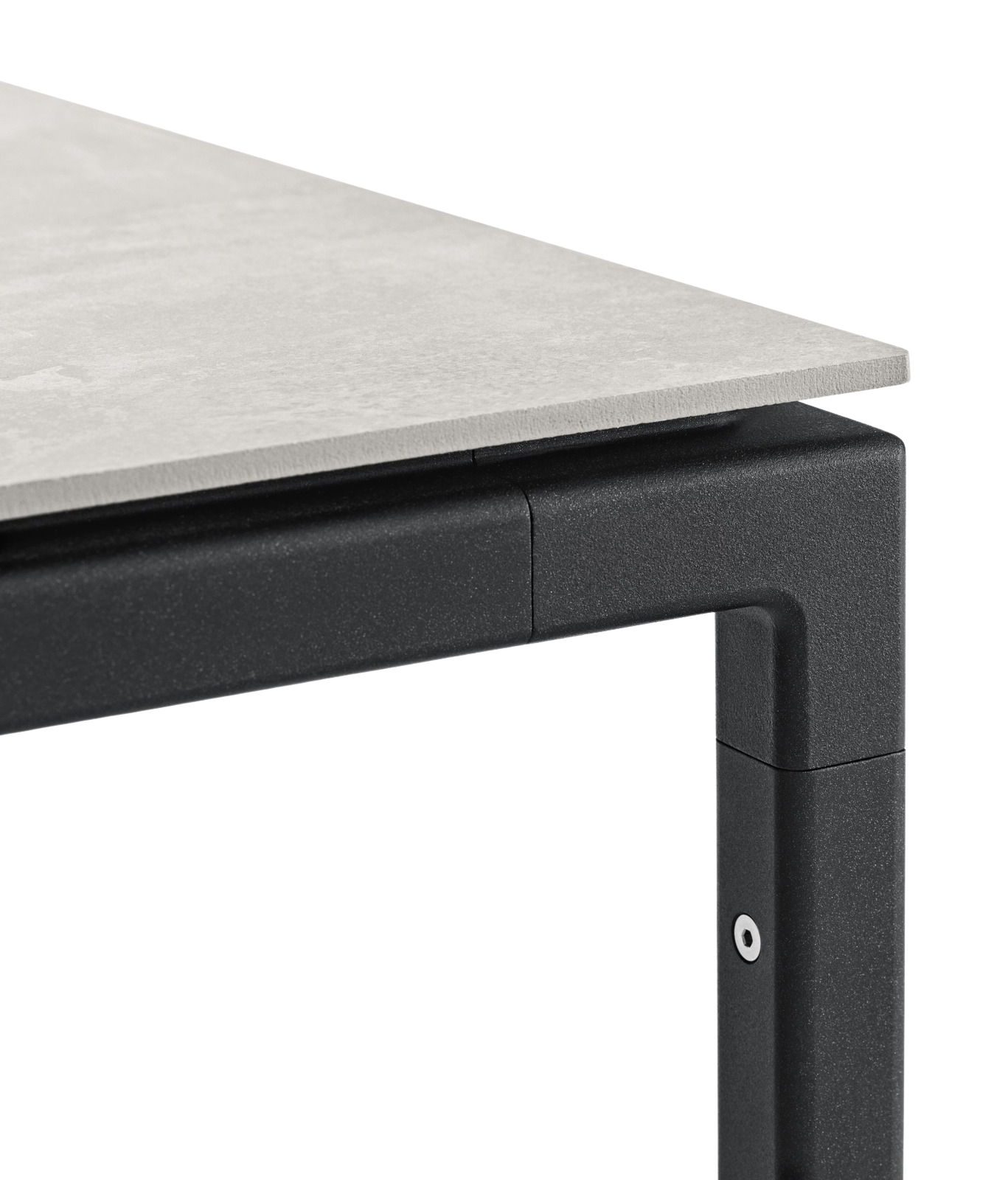 Detailaufnahme Vipp Tisch groß: Graue Tischplatte aus Stein auf schwarzem, pulverbeschichtetem Stahlgestell.