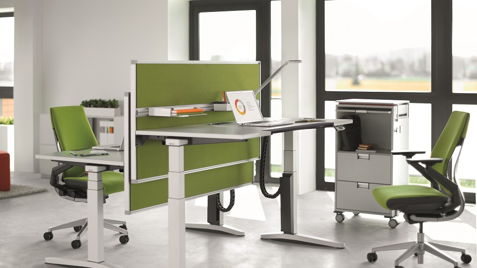 Ology Sitz-Steh-Tisch von Steelcase im modernen Büro mit höhenverstellbarem Schreibtisch und Bürostuhl.
