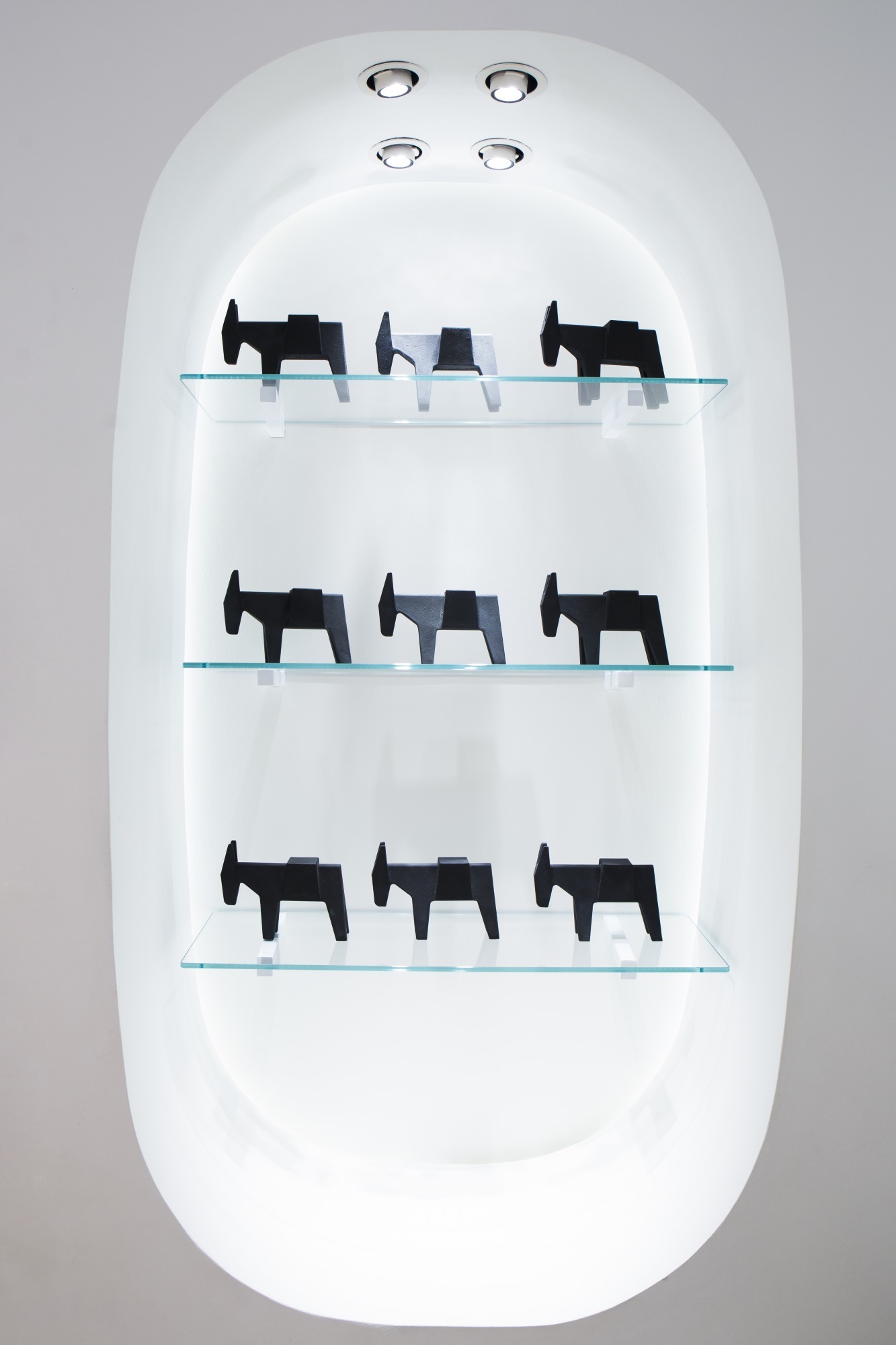 Regal mit mehreren Ettore Türstoppern von Magis in Form von Eseln, schwarz und grau.