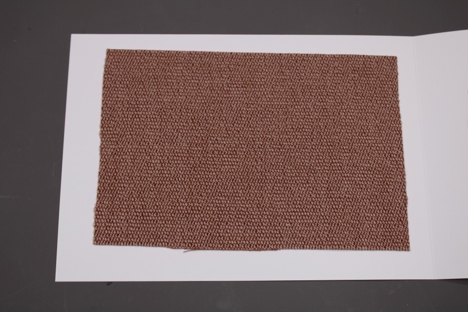 Stoffmusterkarte Gruppe 91 Cor: Nahaufnahme eines braunen, gewebten Stoffmusters für Möbel und Polster.