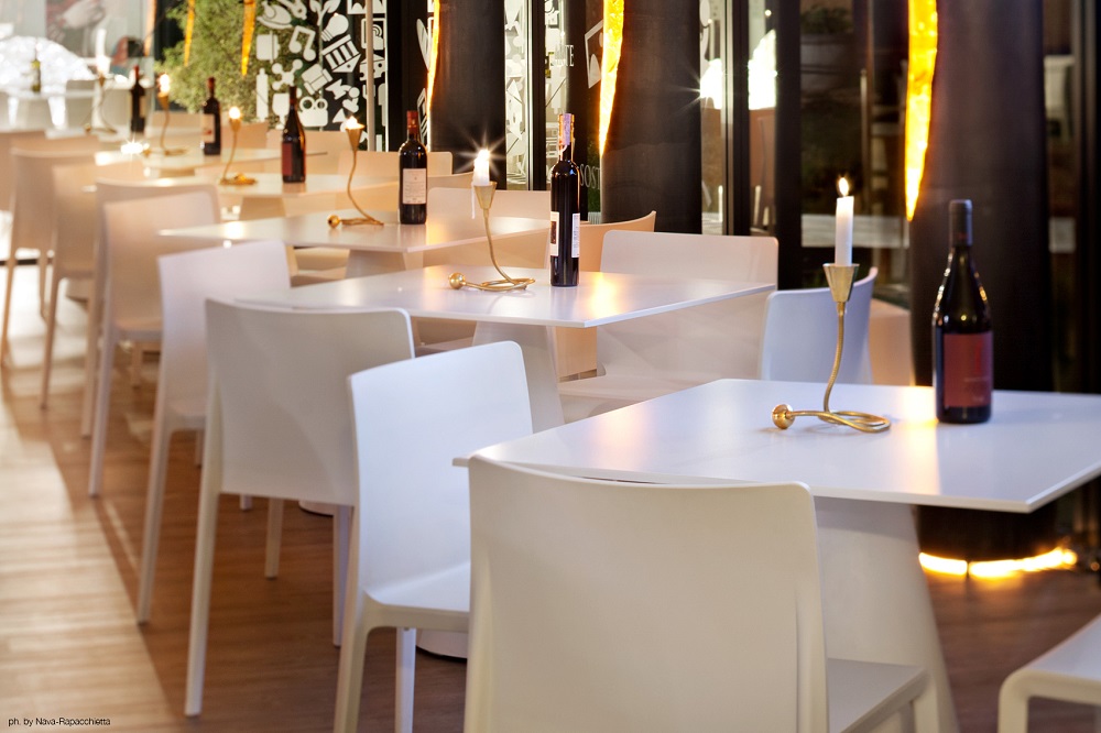 Miracolo Kerzenständer von Catellani & Smith auf weißem Tisch mit Kerze und Weinflasche.