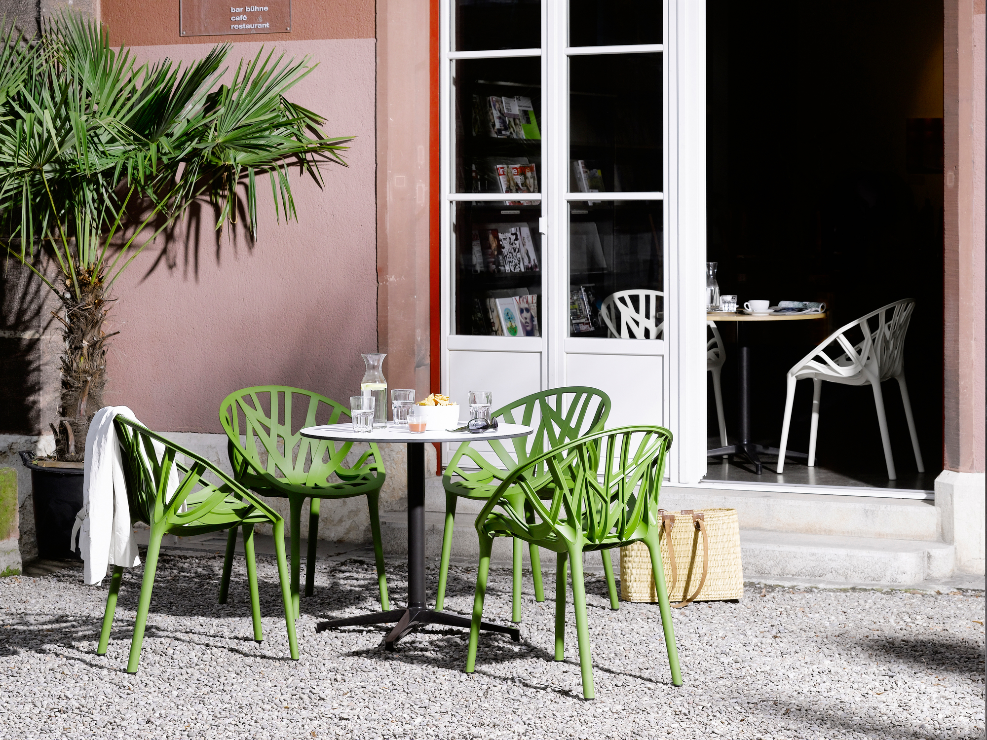 Runder Bistro Table Tisch von Vitra, Durchmesser 79,6 cm, mit grünen Stühlen im Außenbereich.