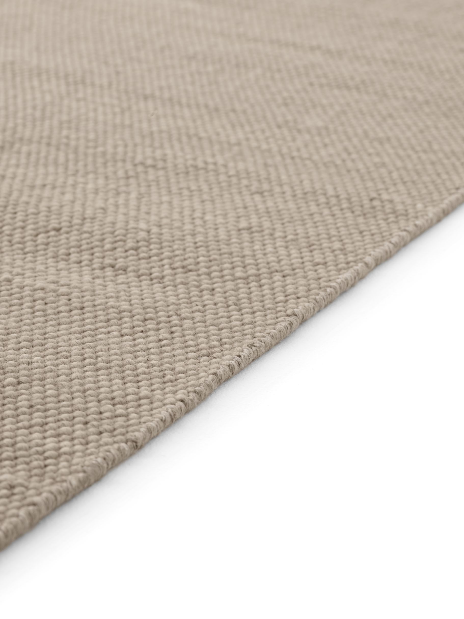 Detailaufnahme Vipp Wollteppich, beiger Teppich aus Wolle mit feiner Textur, ideal für Wohnzimmer und Schlafzimmer.