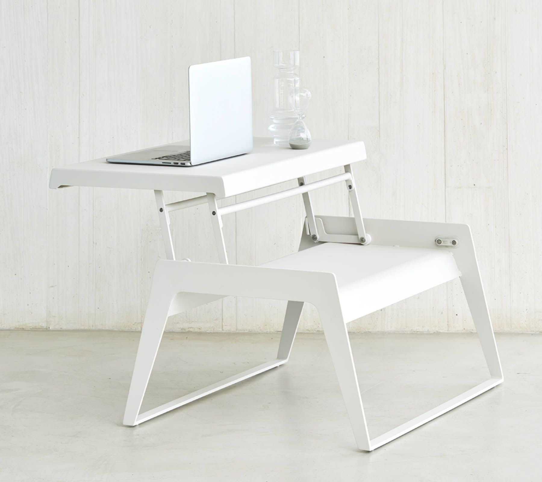 Weißer Cane-Line Chill-out Couchtisch mit Laptop und Deko, ausgeklappt als Beistelltisch.