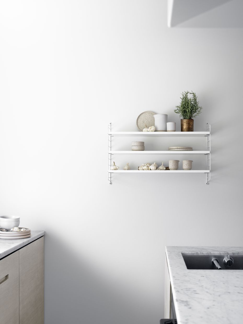 Wandregal mit drei weißen Regalböden und String Furniture Wandleiter im minimalistischen Küchendesign.