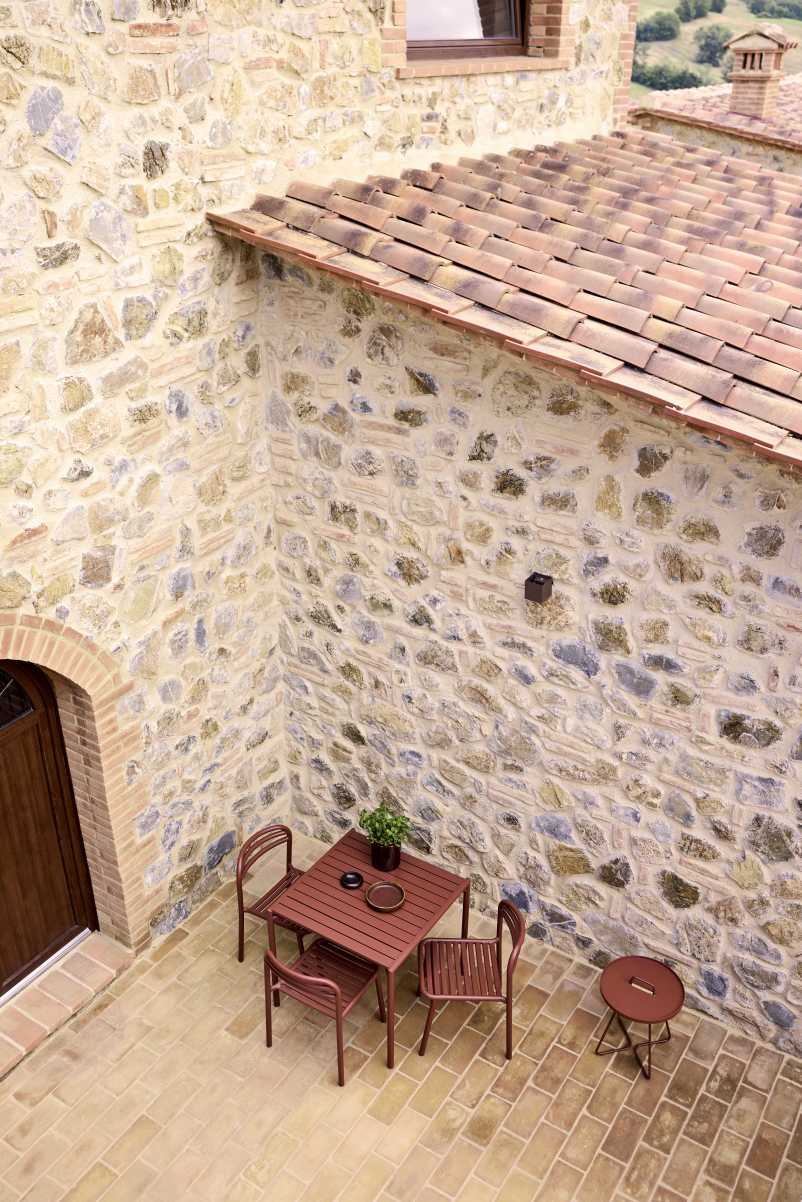 Bliss Esstisch von Cane Line im Außenbereich mit Stühlen und Beistelltisch.