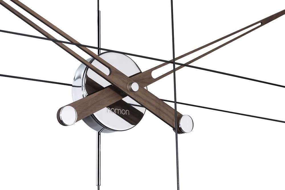 Detailaufnahme der Nomon Delmori Wanduhr mit Holzzeigern und filigranem, schwarzem Drahtgestell. Design Wanduhr für modernes Wohnen.