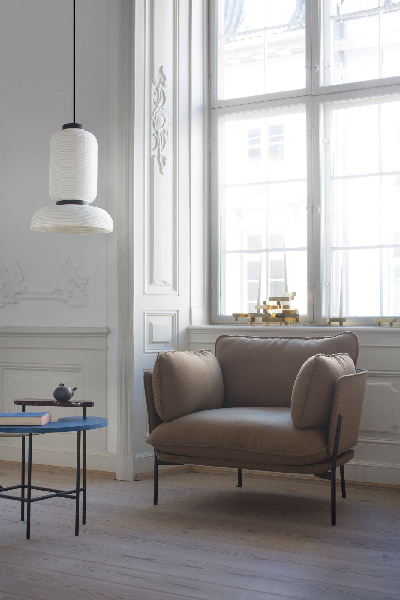 AndTradition Cloud Sessel LN1 in Beige mit Lampe und Beistelltisch in hellem Raum.