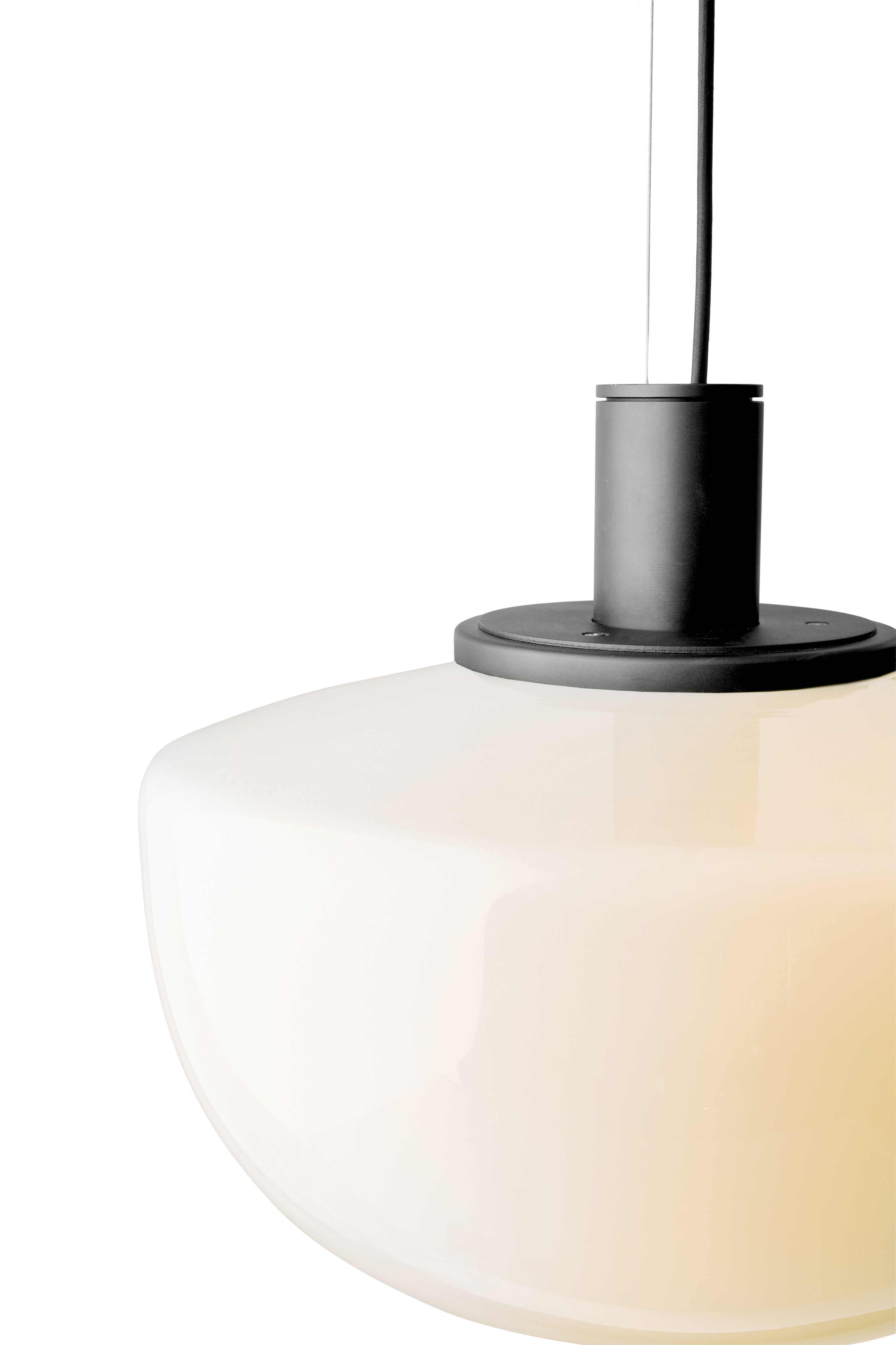 Detailaufnahme der Audo Bank Pendelleuchte mit opalweißem Glasschirm und schwarzer Aufhängung.