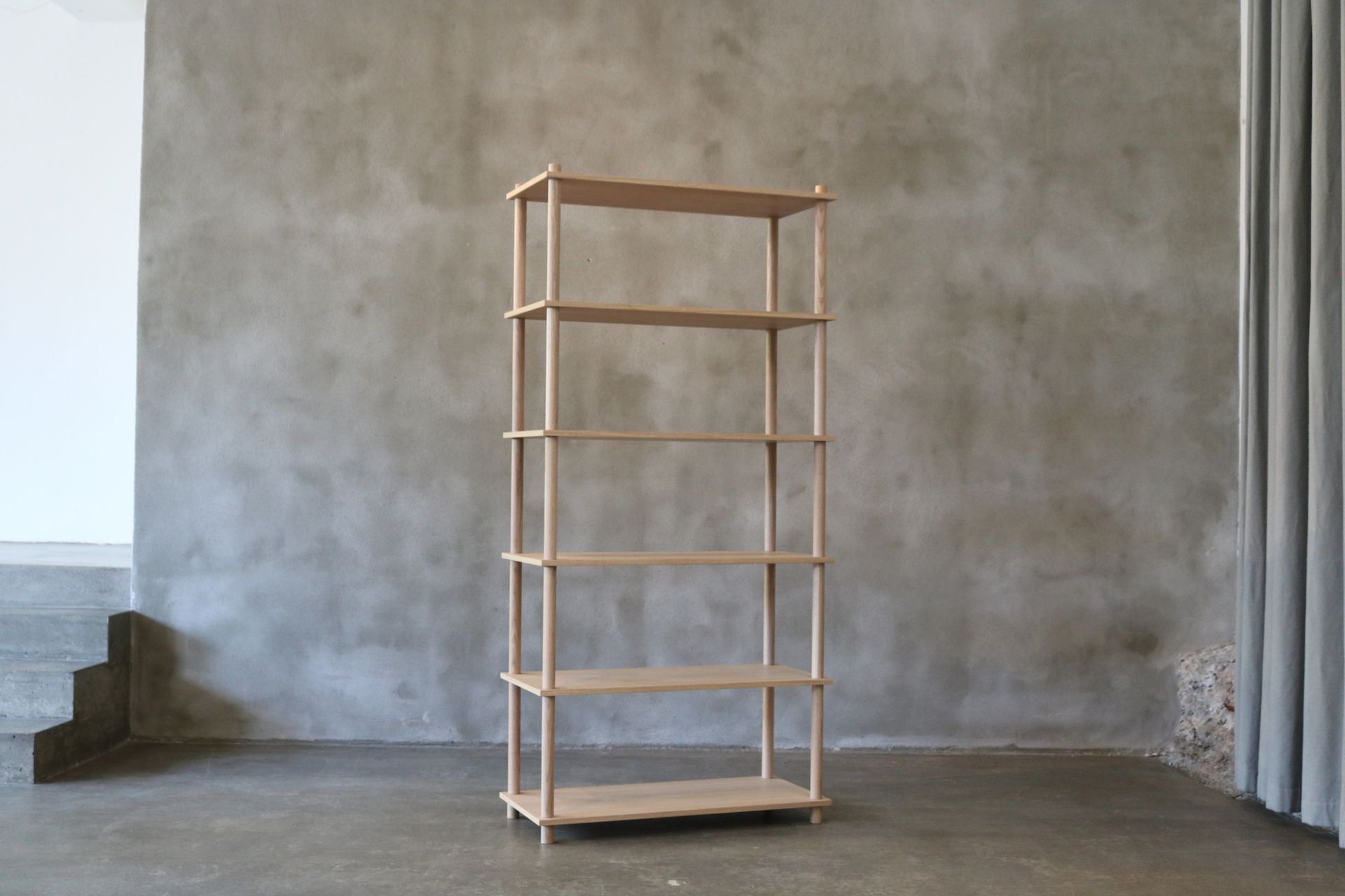 Elevate Regal: Freistehendes, helles Holzregal mit fünf Böden vor grauer Wand.