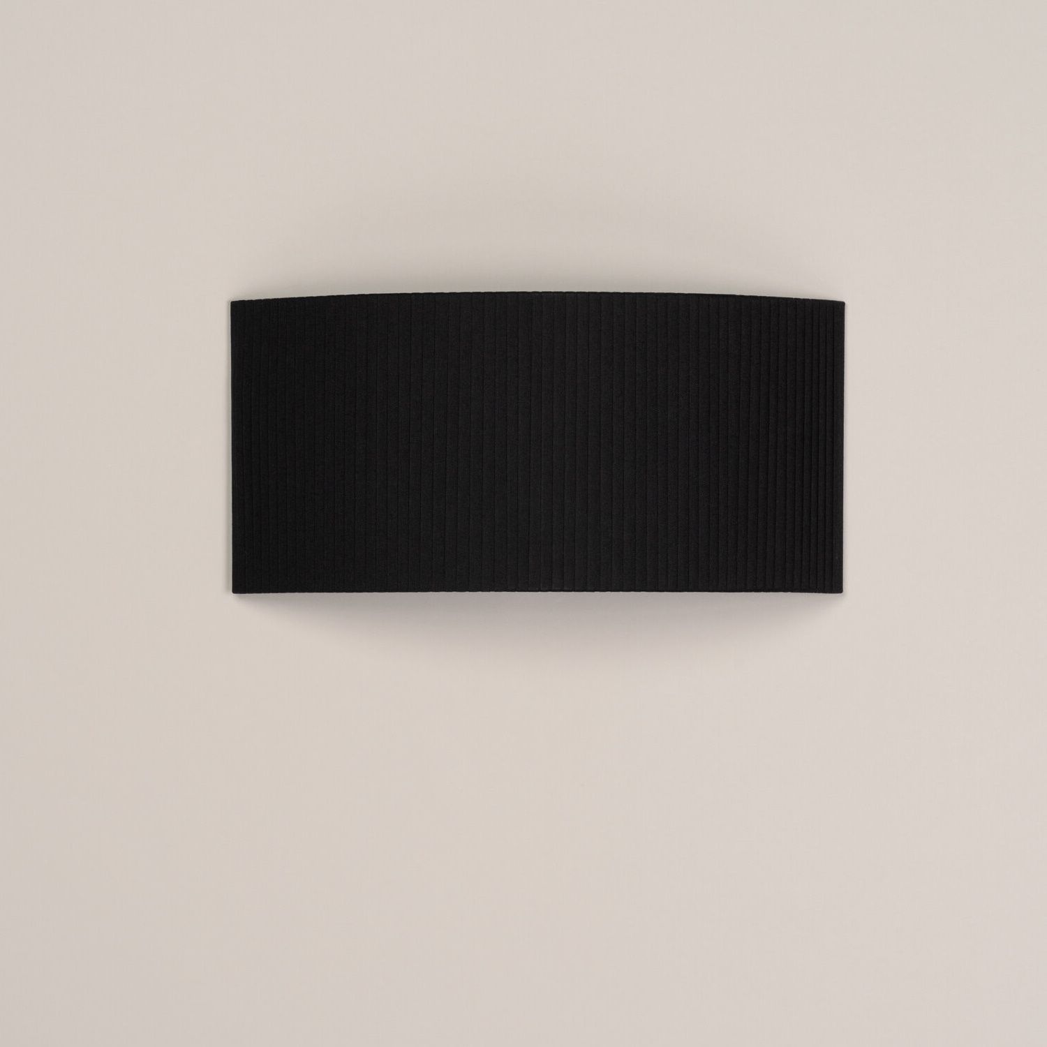 Rechteckige, schwarze Comodín Wandleuchte von Santa & Cole mit gerippter Oberfläche für stimmungsvolle Beleuchtung.