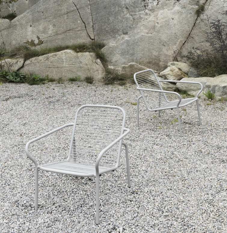 Zwei graue Vig Lounge Sessel von Normann Copenhagen im Außenbereich auf Kiesboden.