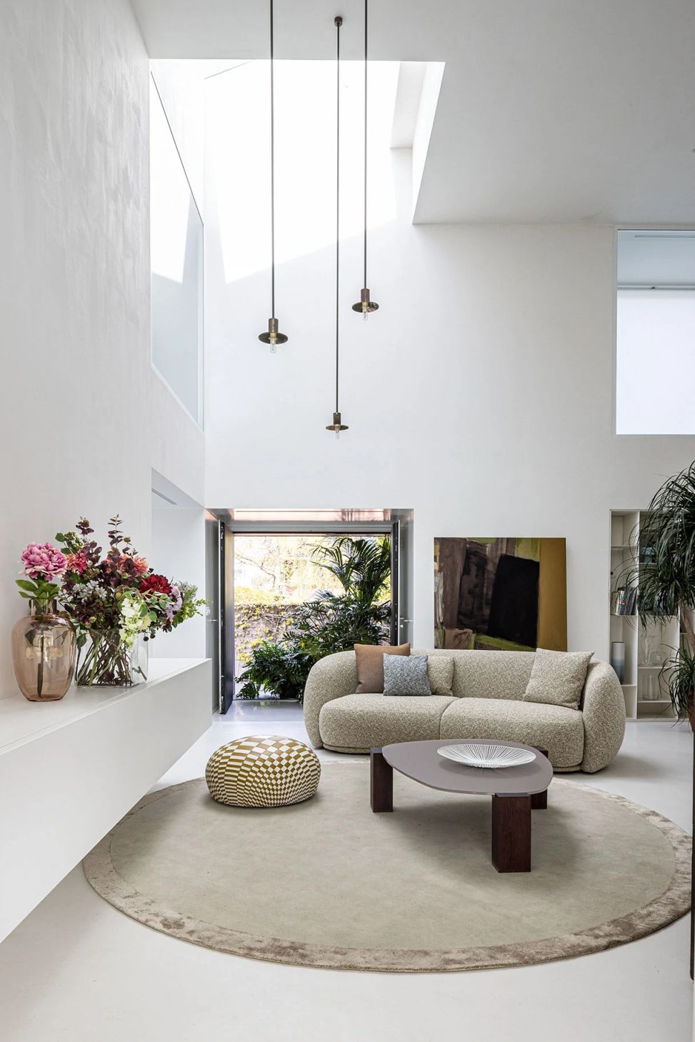 Helles Wohnzimmer mit Pacific Sofa von Moroso, Teppich, Tisch und Dekoration.