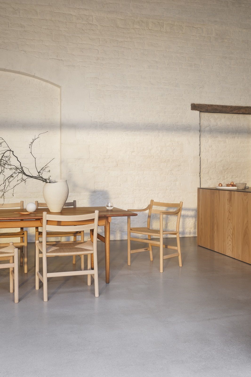 CH46 Armchair von Carl Hansen & Søn am Esstisch, skandinavisches Design mit Armlehnen.