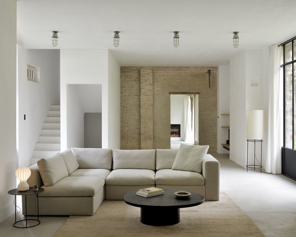 Ovaler Slice Minerals Couchtisch von Ethnicraft in modernem Wohnzimmer mit beigem Sofa und Teppich.