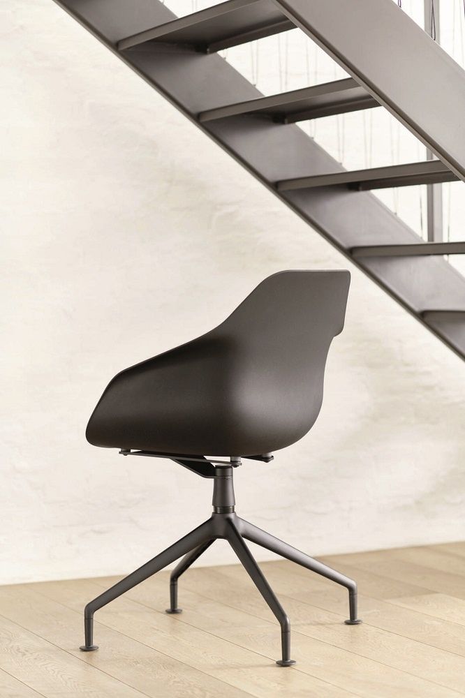 Schwarzer Yonda Universalstuhl von Wilkhahn mit Viersternfuß vor einer Treppe, Bürostuhl für modernes Arbeiten.