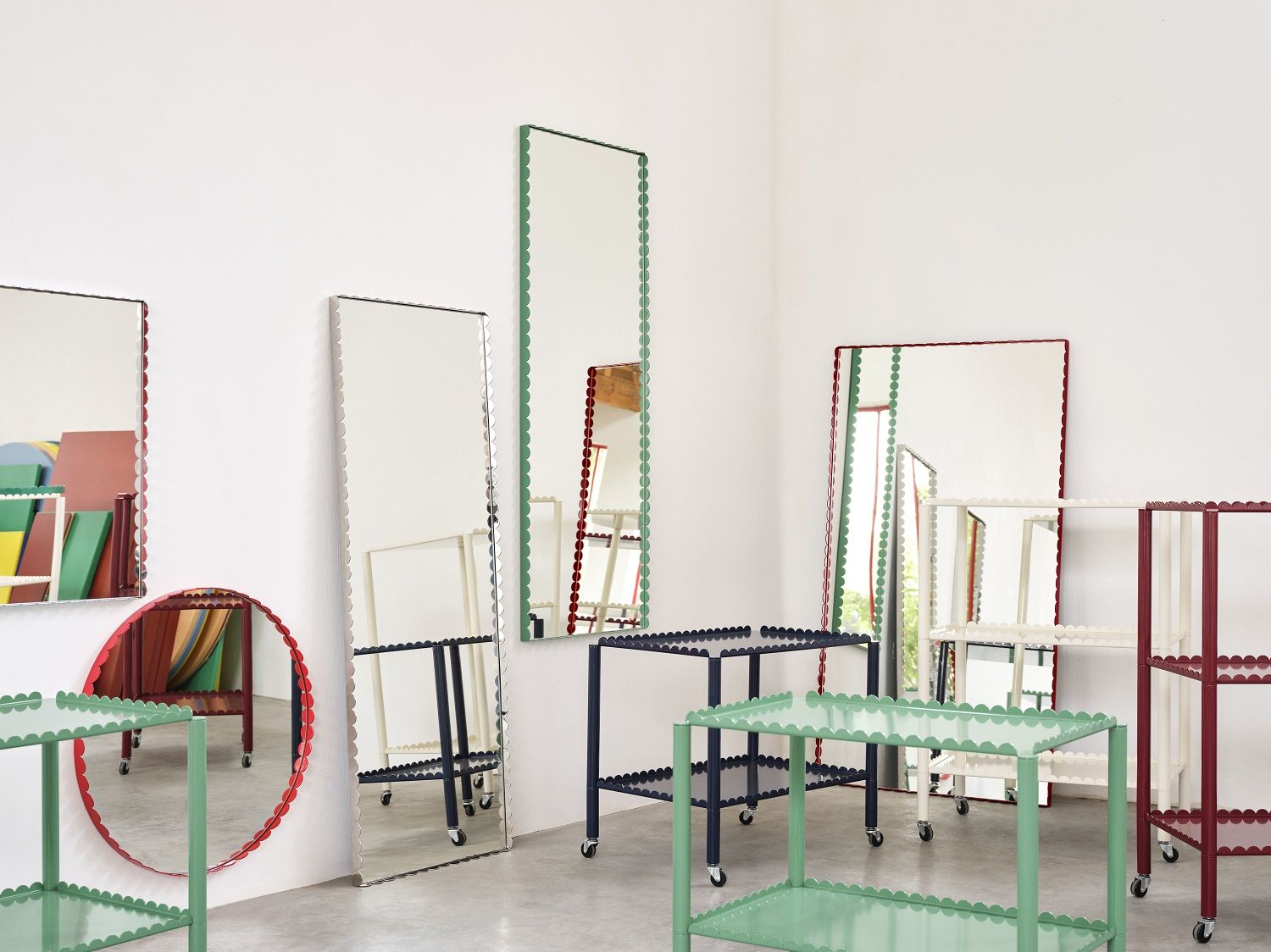 Mehrere Arcs Spiegel von Hay in Grün und Burgunderrot, rechteckig und rund, in einem Raum.