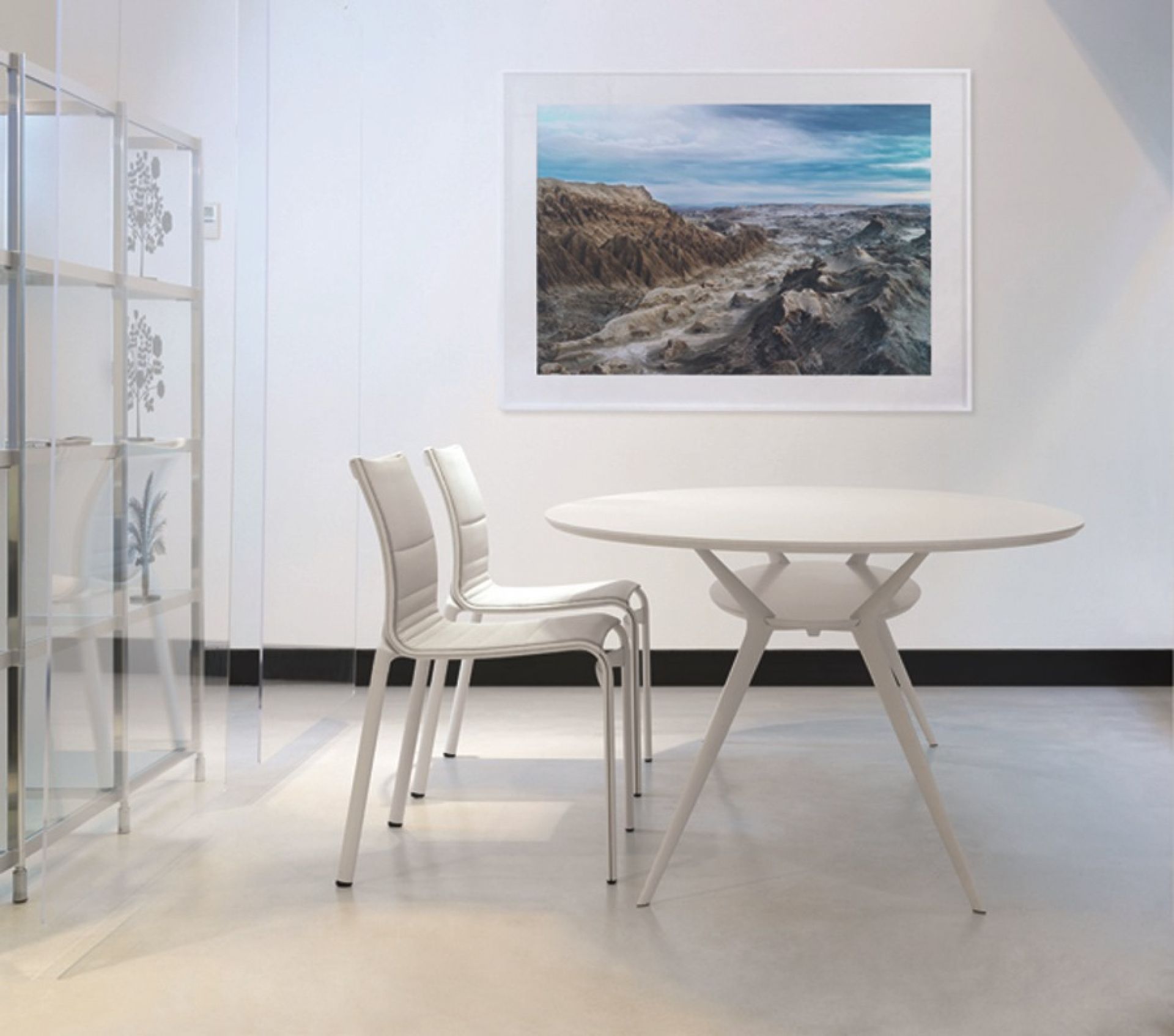 Weißer Biplane Tisch von Alias mit zwei Stühlen in einem hellen Raum.