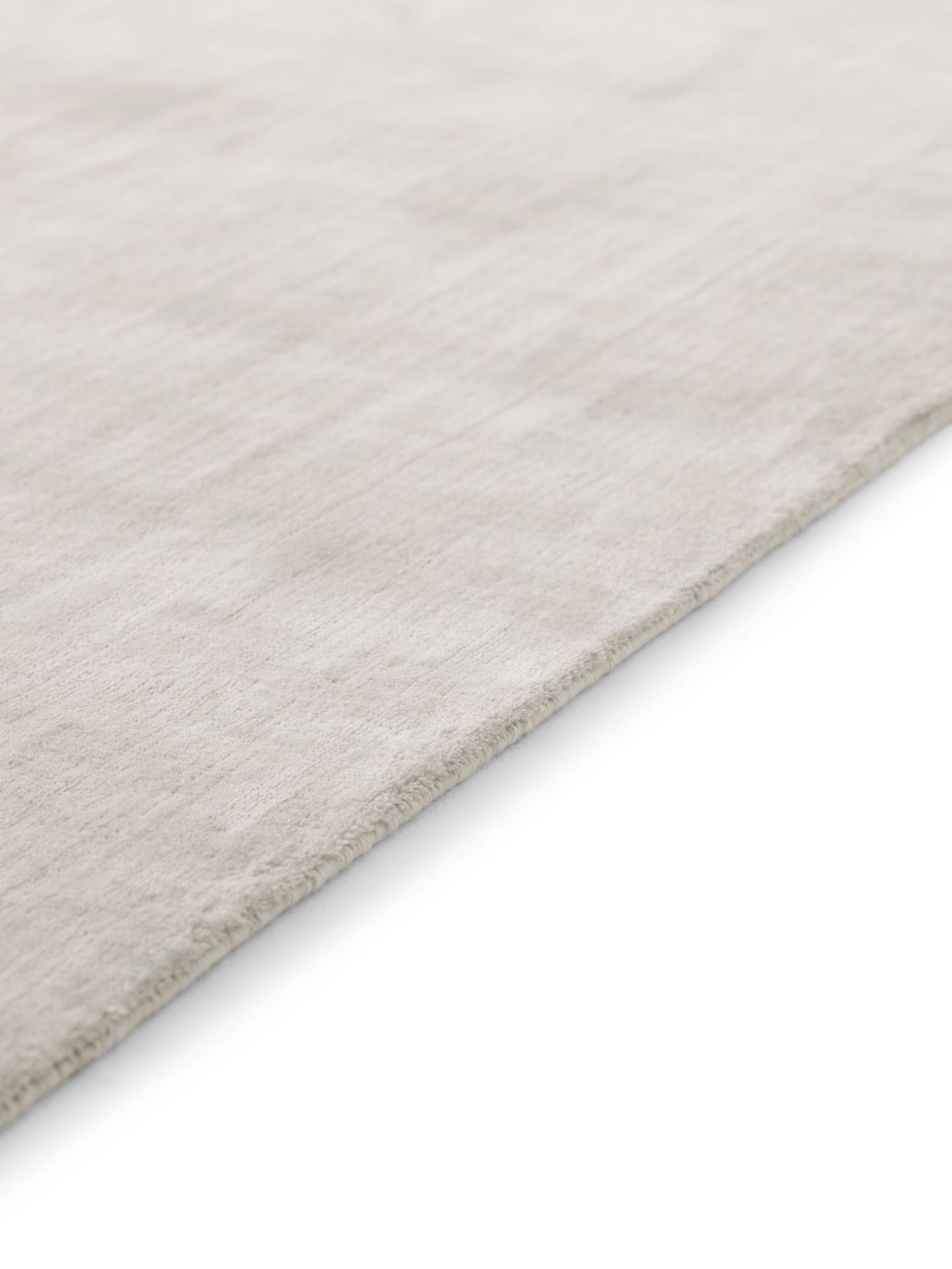 Detailaufnahme des Vipp Wollteppichs (400x300) in Beige, hergestellt aus Wolle und Bambusfasern.