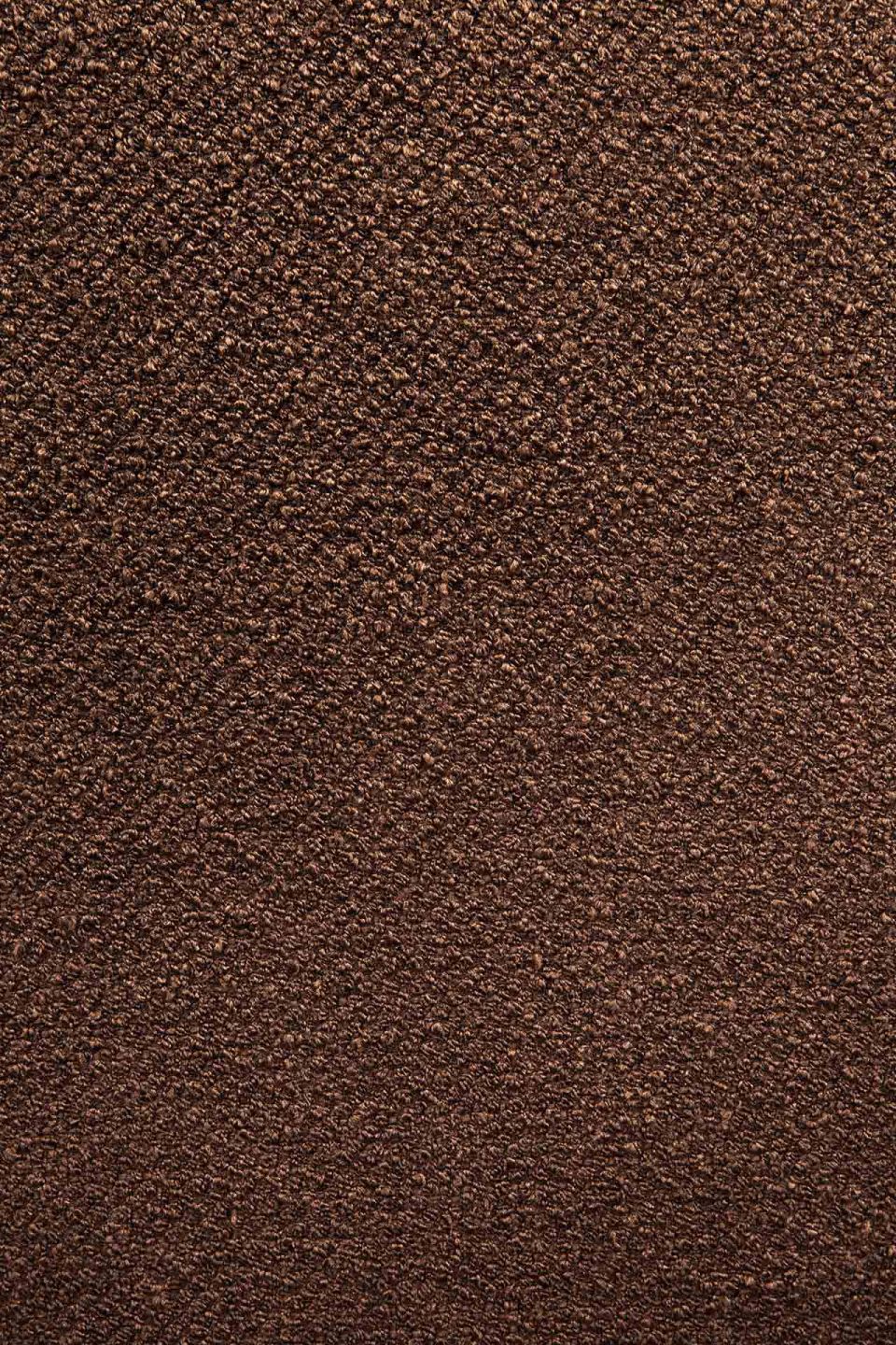 Detailaufnahme des kupferfarbenen Stoffbezugs vom Ethnicraft Barrow Sitzhocker. Gemusterte Textur für Wohnzimmer und mehr.