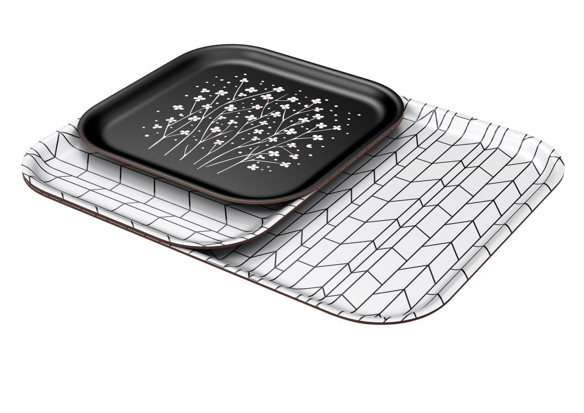 Vitra Tablett: Schwarzes Serviertablett mit Blumenmuster liegt auf weißem Tablett mit geometrischem Muster.