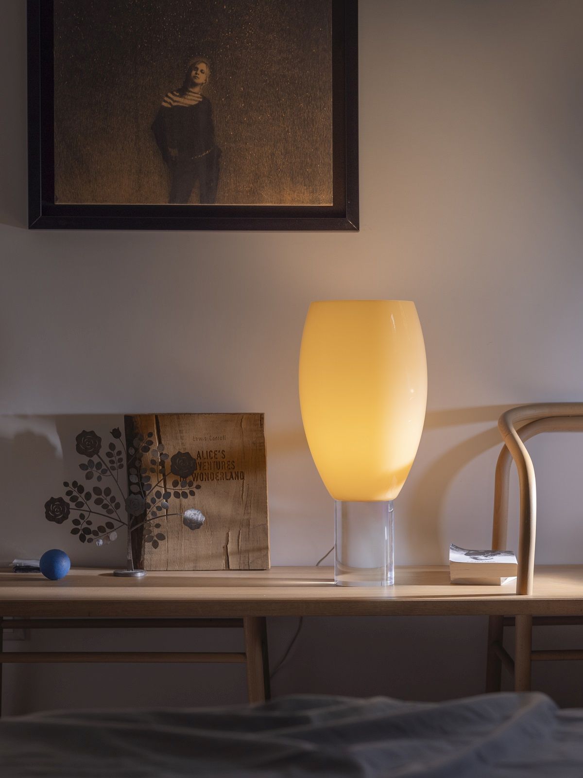 Nahaufnahme der leuchtenden Buds Tischleuchte Cipria von Foscarini auf einem Holztisch.