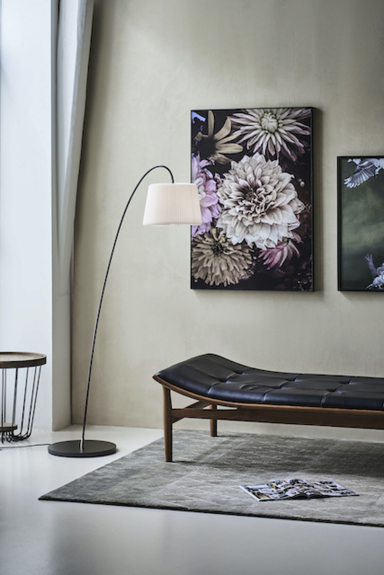 Snowdrop Stehleuchte von Le Klint: Elegante Bogenleuchte mit plissiertem Lampenschirm im stilvollen Wohnzimmer.