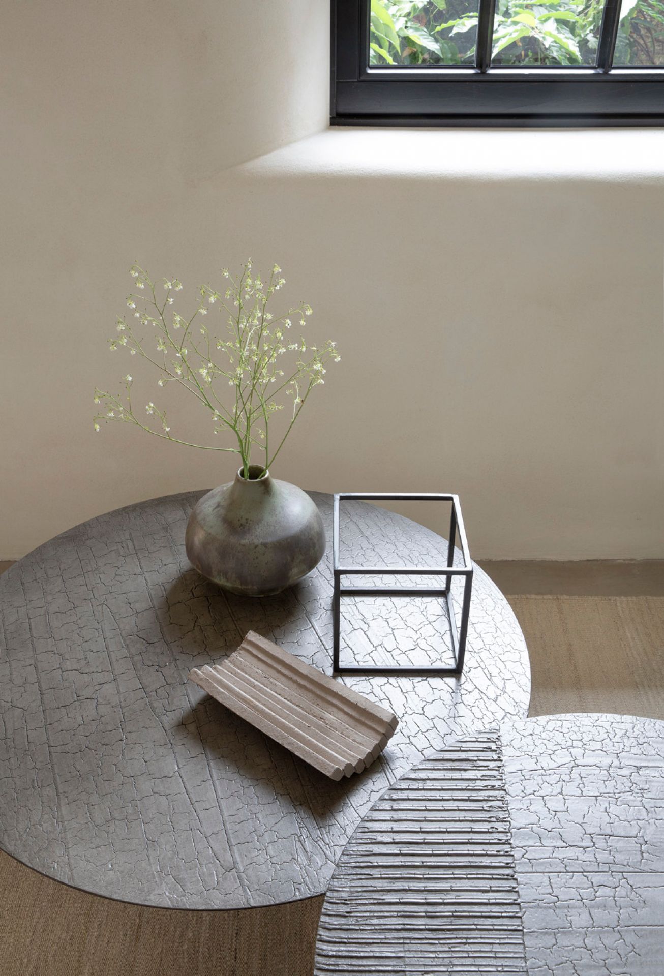 Luna Couchtisch Lava von Ethnicraft: Runder Wohnzimmertisch mit einzigartiger, strukturierter Oberfläche und Deko.