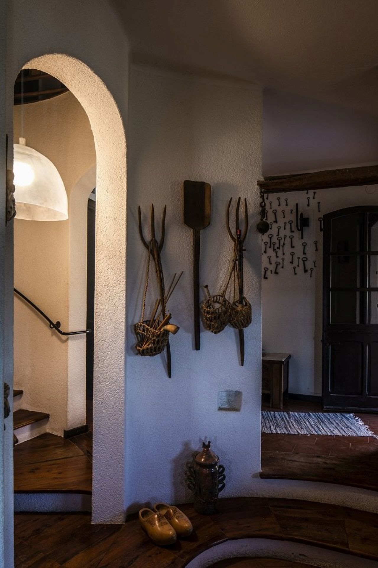 Ansicht einer Foscarini Pendelleuchte im Flur eines Hauses mit rustikalem Dekor.