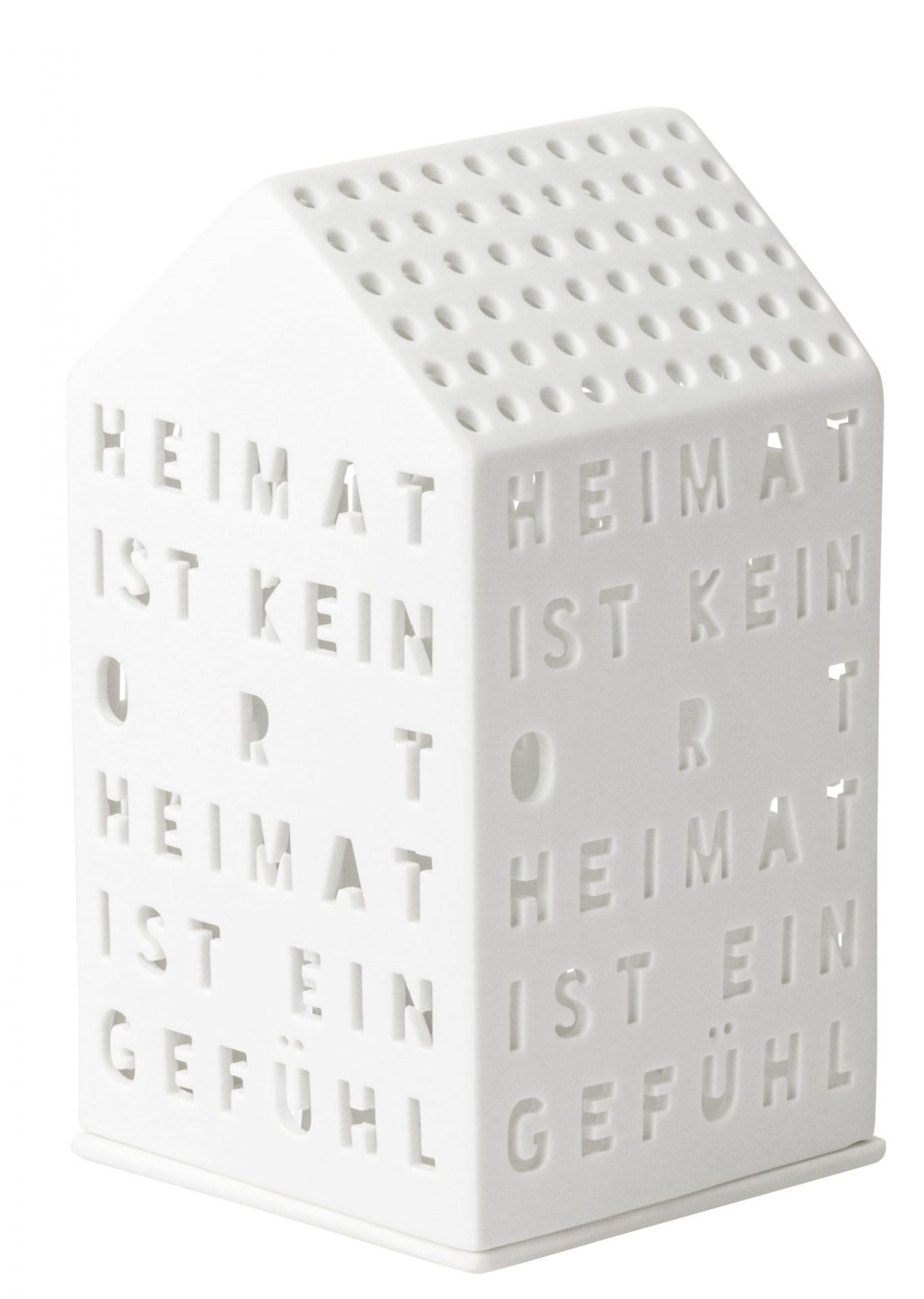 Weißes Lichthaus "Heimat ist kein Ort" von Räder mit Ausstanzungen und Löchern für Teelichter.