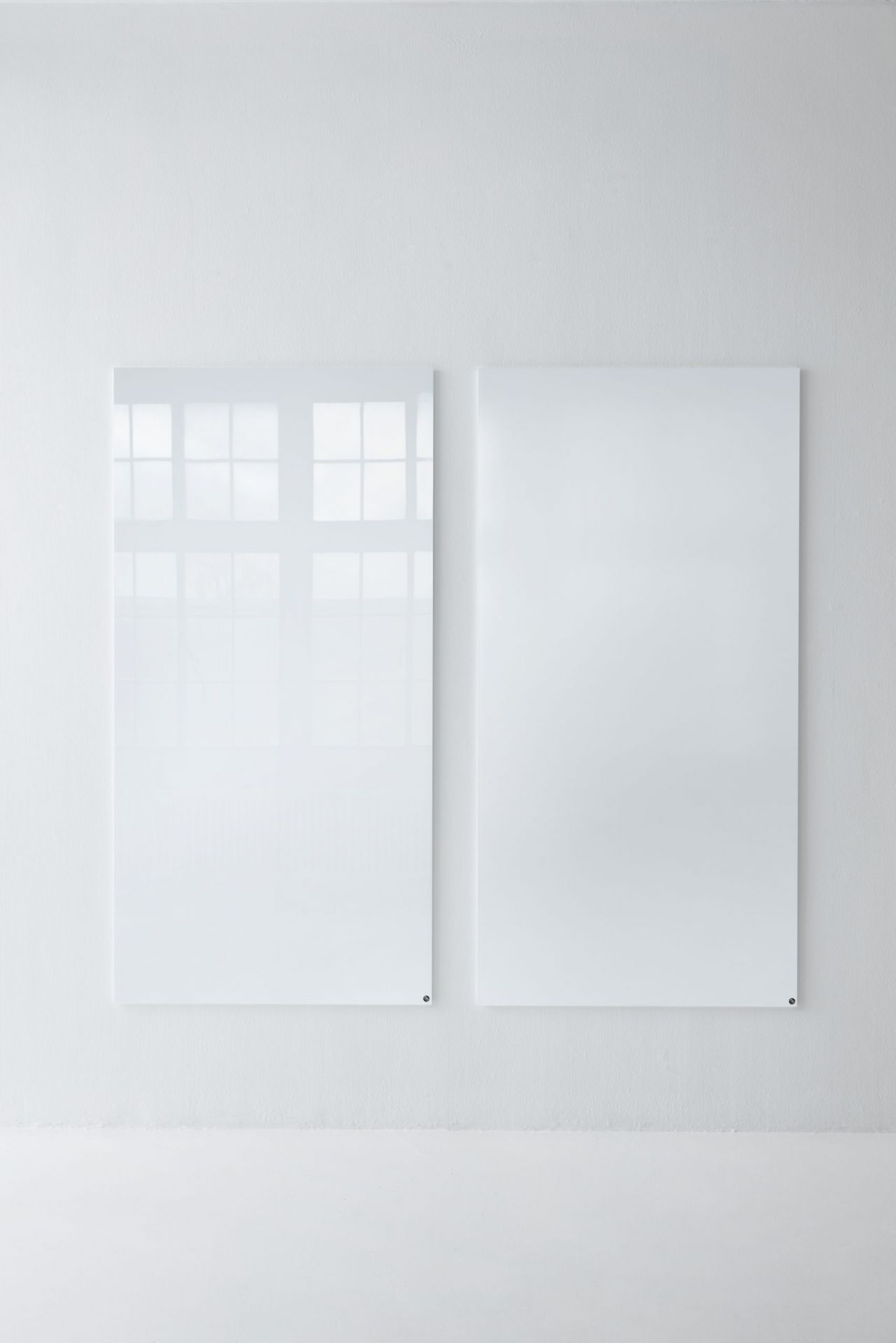 Zwei weiße, magnetische Chat Board Glastafeln an einer weißen Wand, Bürobedarf.