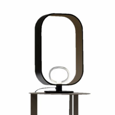 Filipa Tischleuchte von Tooy: Moderne Lampe mit schwarzem Rahmen und kreisförmigem Leuchtmittel.