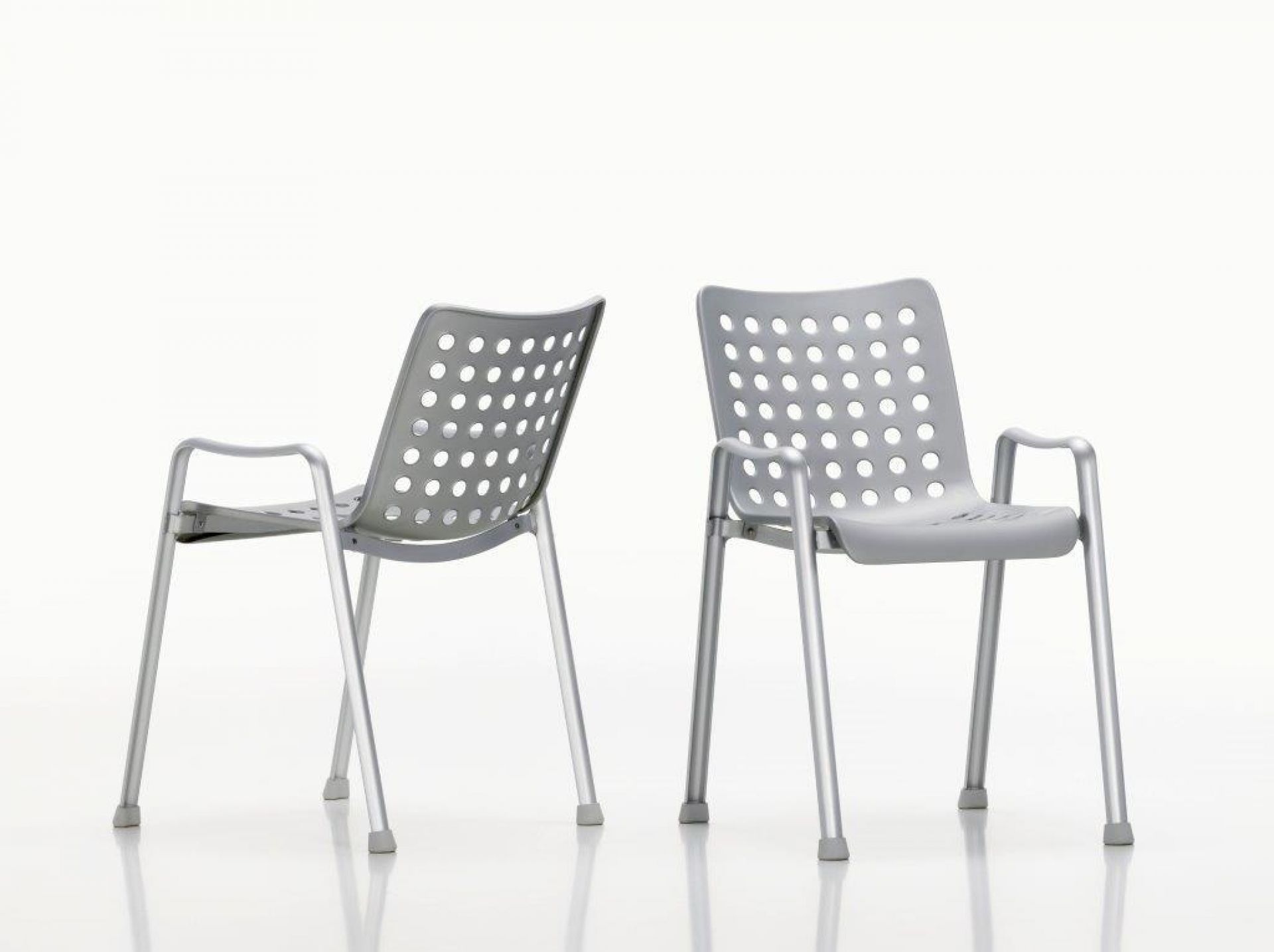 Zwei graue Vitra Stühle im Landi Design mit Armlehnen und Lochmuster auf weißem Hintergrund.
