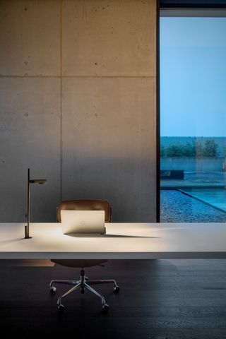 Kido Desk Tischleuchte von Belux mit fester Befestigung auf einem modernen Schreibtisch.