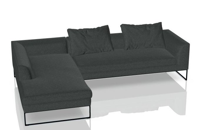 Graues Mell Lounge Sofa mit Recamiere und Kissen auf schlanken, schwarzen Füßen.