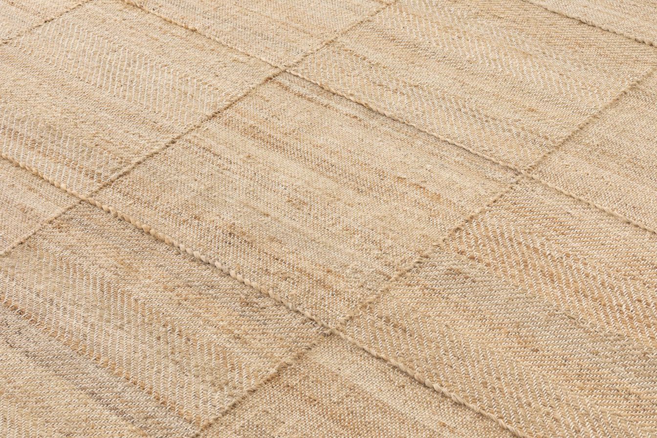 Detailaufnahme des Roots Teppichs von Gan, ein beiger Teppich mit quadratischem Muster.