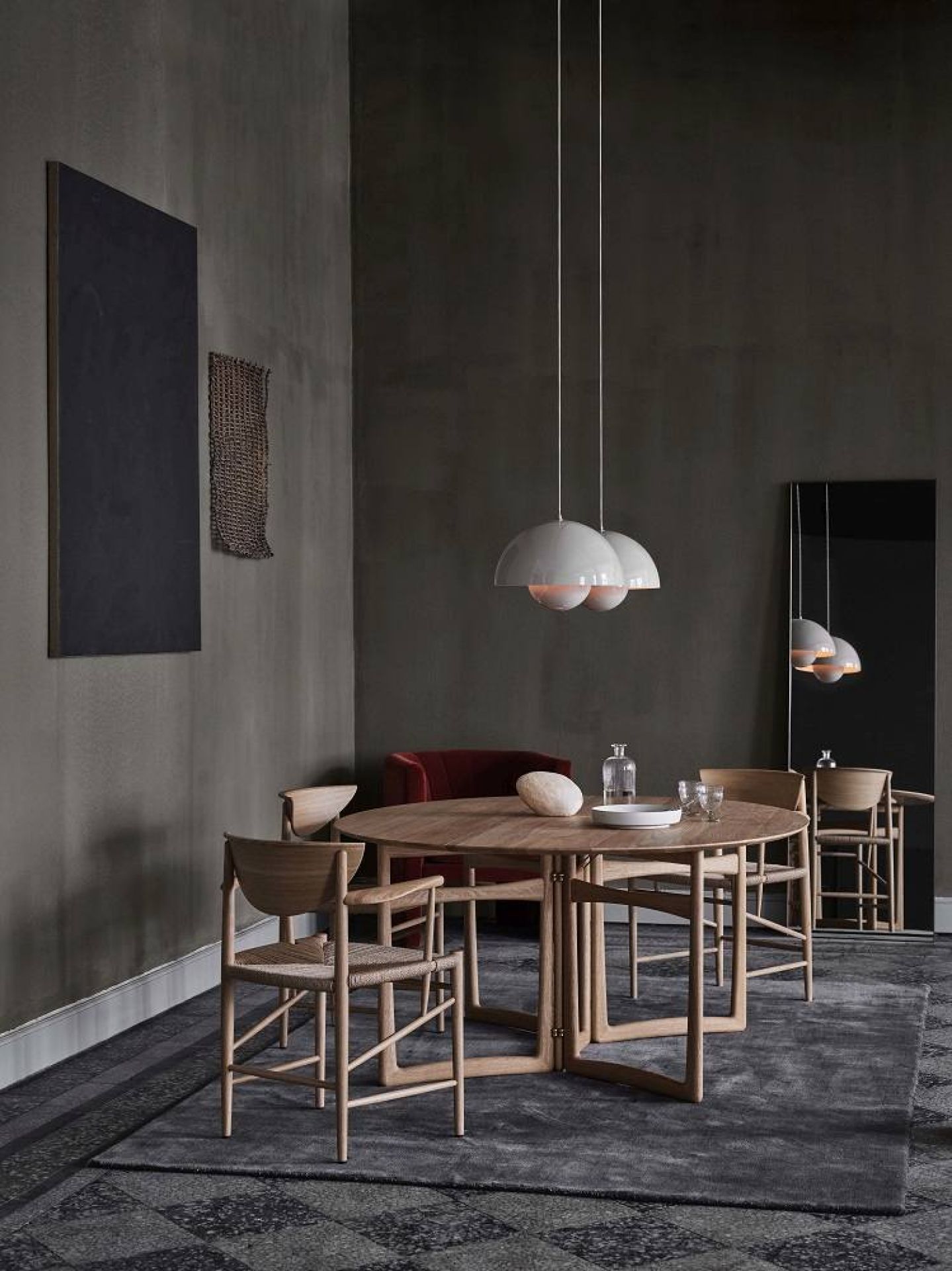 Drawn HM4 Stuhl mit Armlehnen von AndTradition an einem Esstisch mit Stühlen.