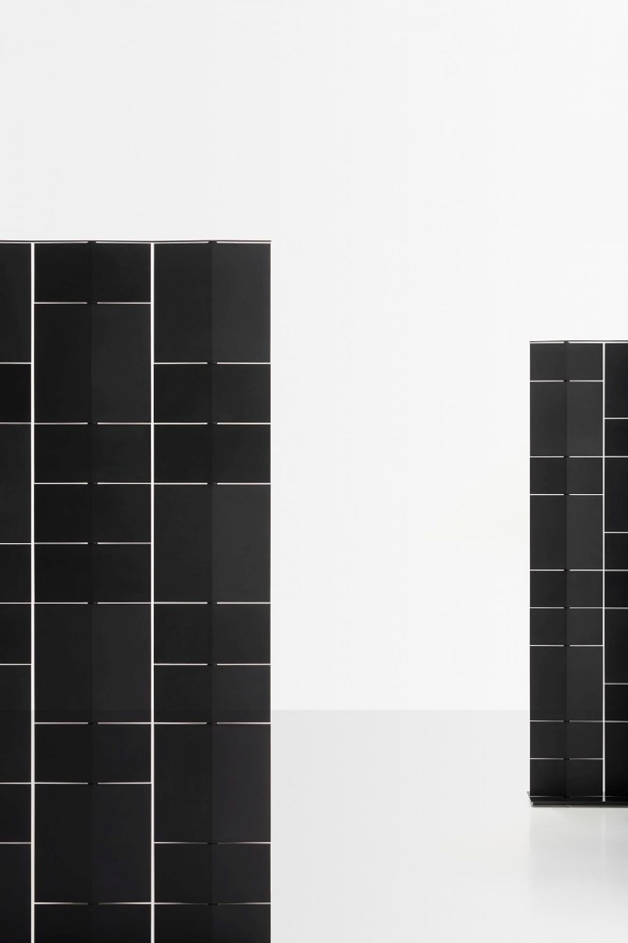 Zwei schwarze Divide It Raumteiler Module von MDF Italia vor weißem Hintergrund.