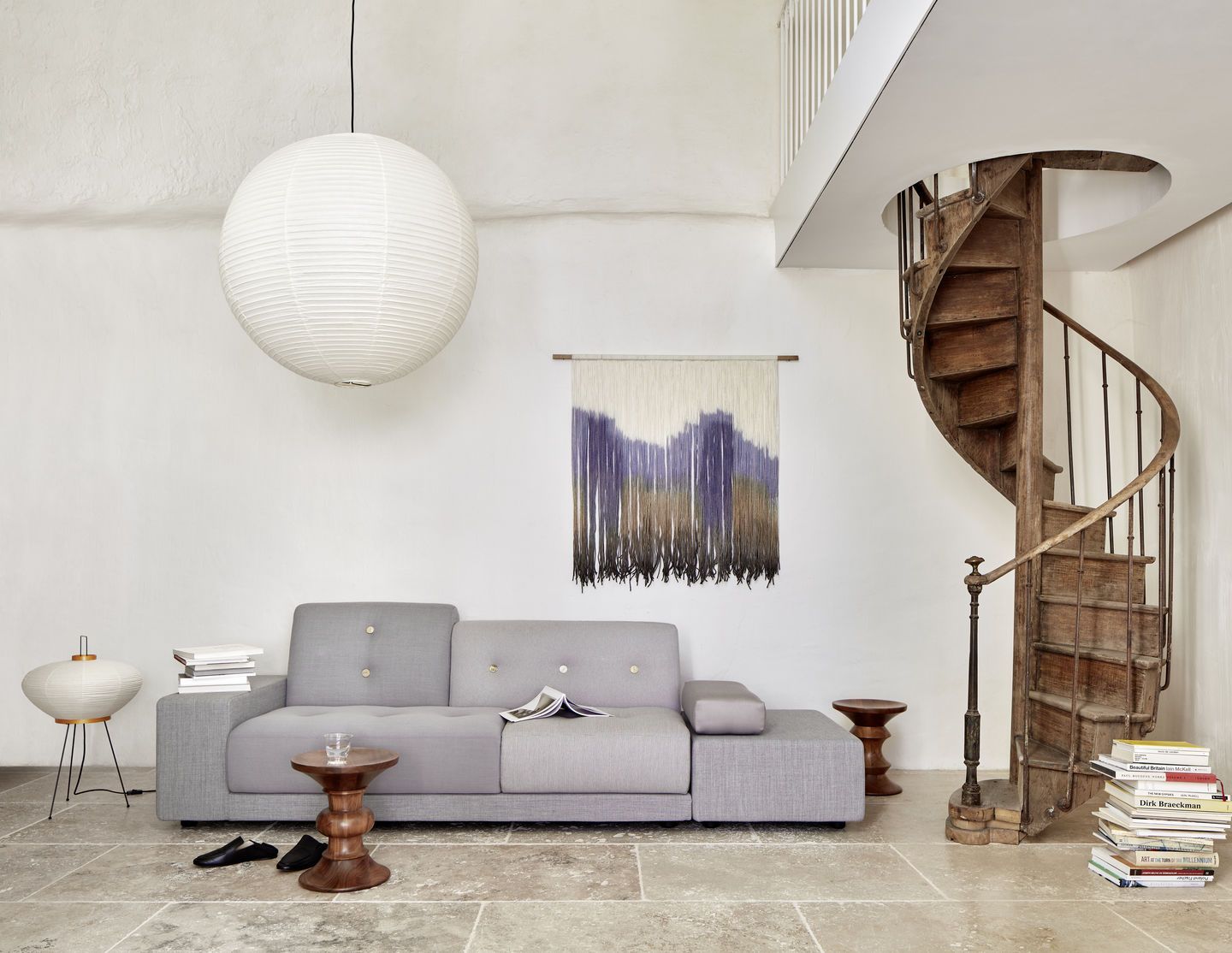 Graues Polder Sofa von Vitra in einem hellen Wohnzimmer mit Wendeltreppe. Gemütliche Sitzgelegenheit.